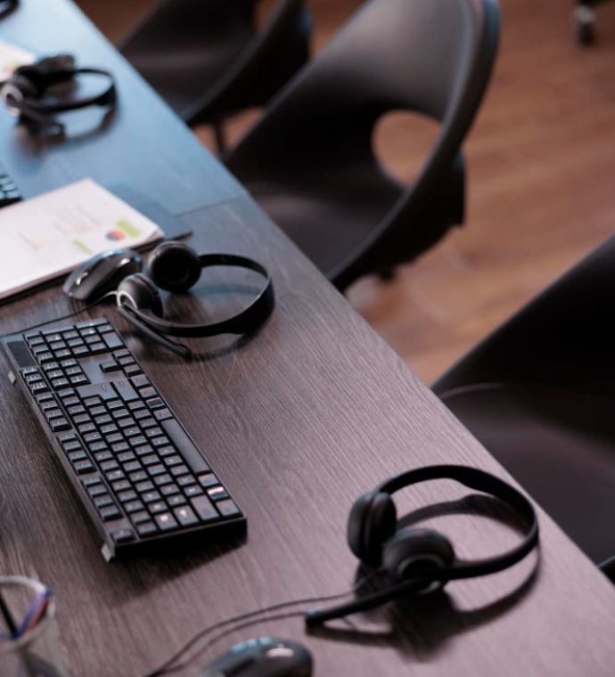 empty-helpdesk-office-with-telephony-equipment-reception-give-assistance-no-people-telemarketing-space-customer-service-client-support-remote-helpline-headphones