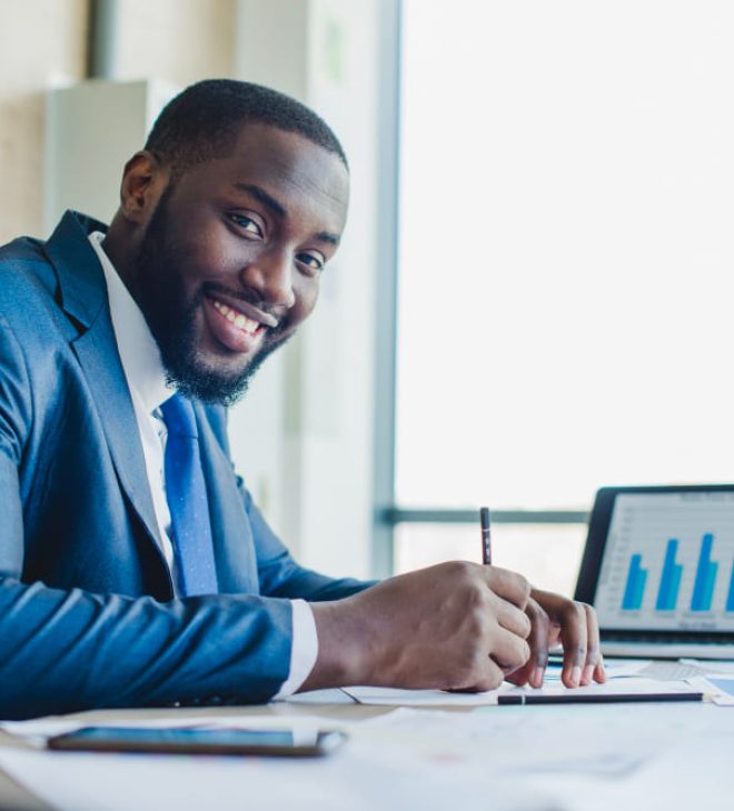 smiling-businessman-signing-contract (1)